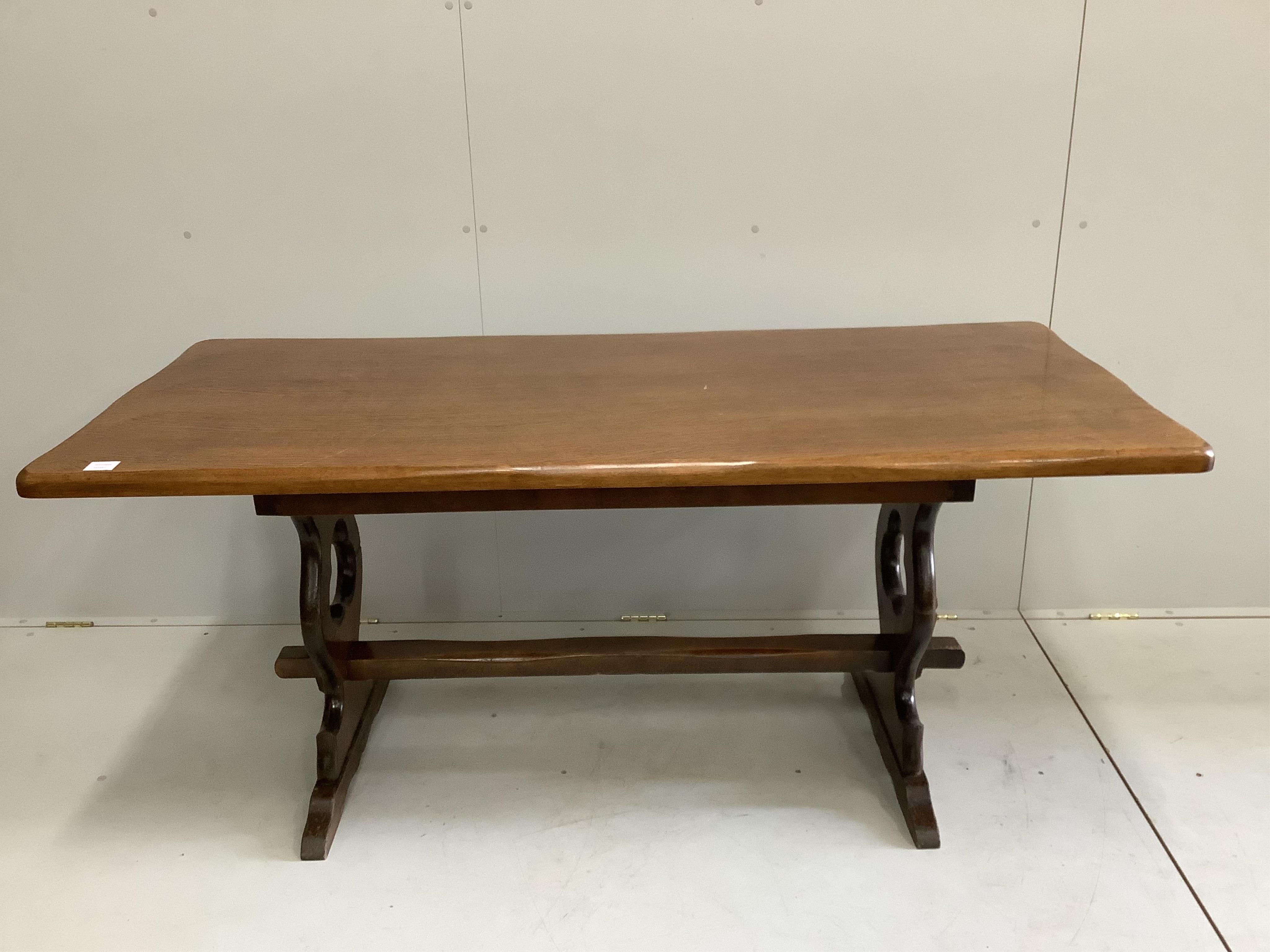 An 18th century style rectangular oak refectory dining table, width 166cm, depth 75cm, height 74cm together with a set of eight oak dining chairs, two with arms